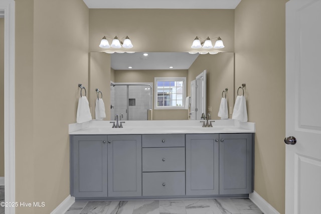 bathroom featuring a sink, marble finish floor, a stall shower, and double vanity