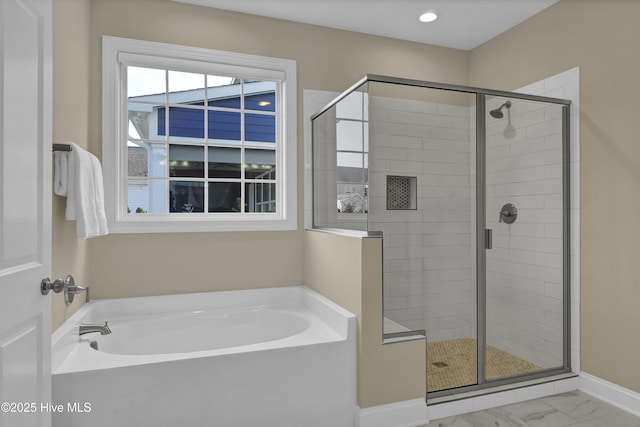 full bath with marble finish floor, a bath, and a shower stall