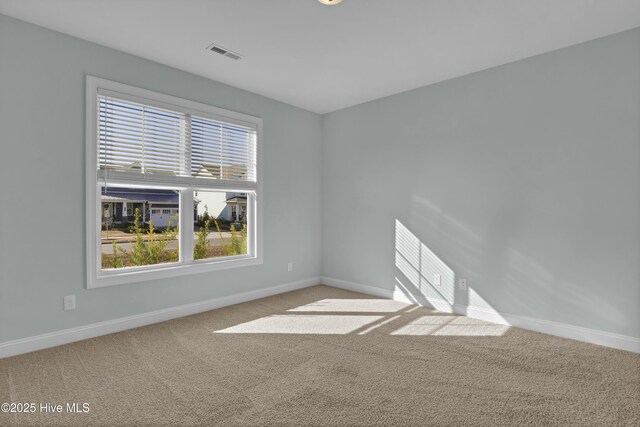 unfurnished room featuring visible vents, baseboards, and carpet floors