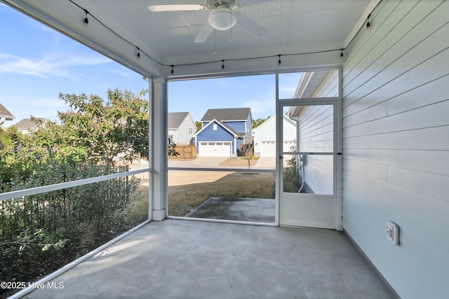 unfurnished sunroom featuring ceiling fan