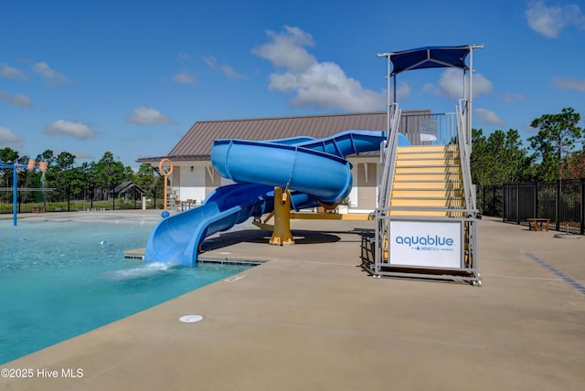 view of playground featuring stairway, a community pool, and fence