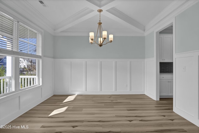 unfurnished dining area with visible vents, coffered ceiling, beam ceiling, light wood-style flooring, and a decorative wall