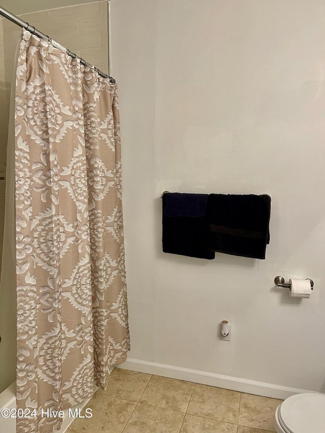 bathroom featuring tile patterned flooring and toilet