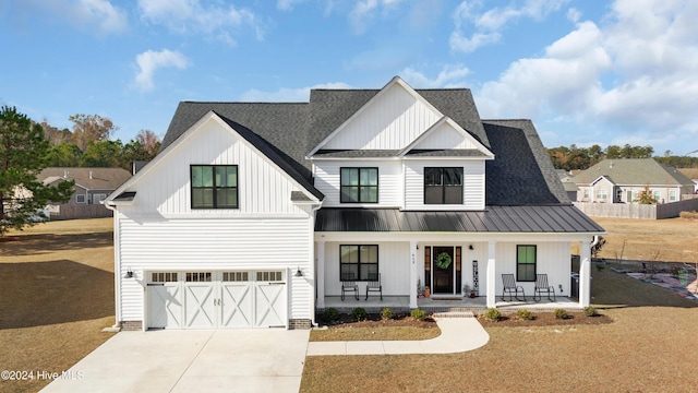 modern farmhouse style home featuring a front yard, a porch, and a garage