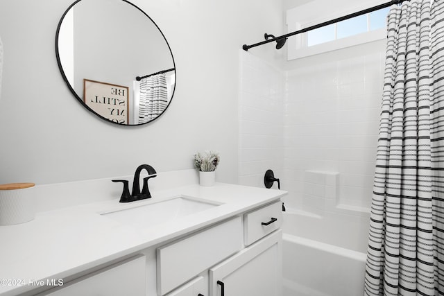 bathroom featuring vanity and shower / bathtub combination with curtain