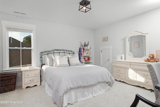 bedroom with light colored carpet