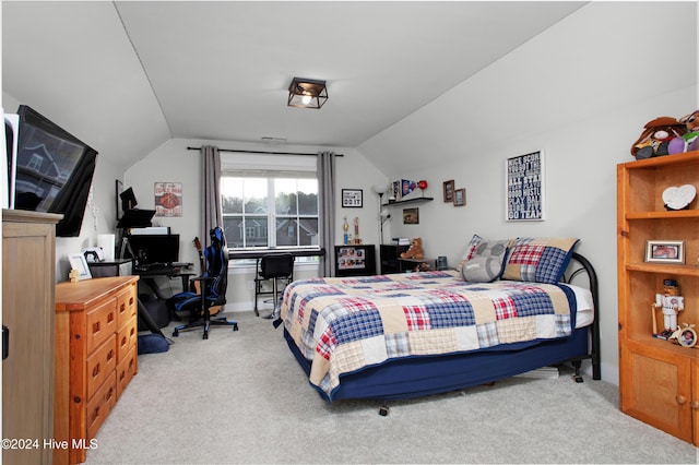 bedroom featuring light carpet and vaulted ceiling