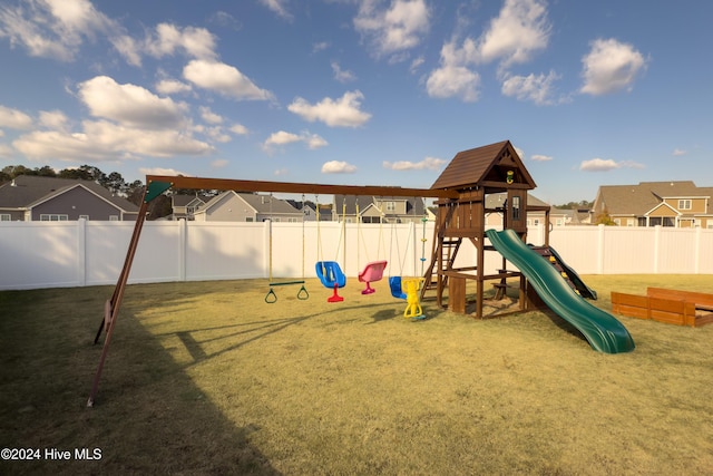 view of playground with a lawn