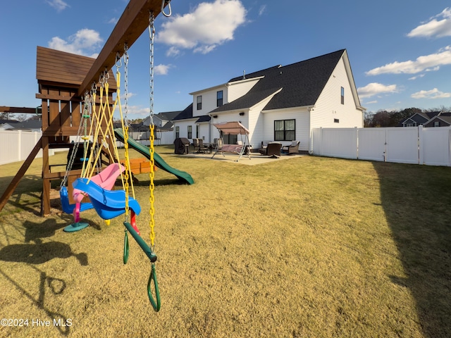 view of play area featuring a lawn and a patio