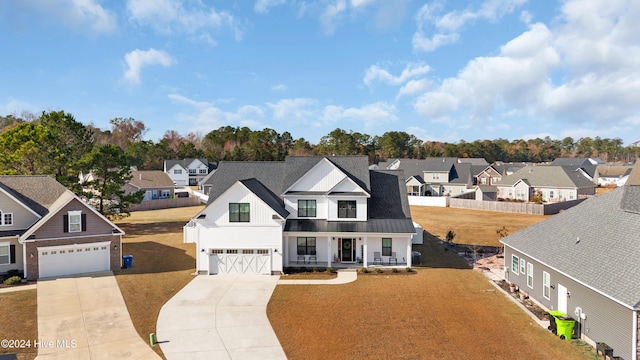 modern farmhouse style home featuring a garage and covered porch