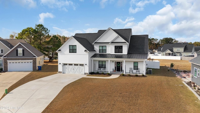 modern farmhouse with central AC unit, a porch, and a garage