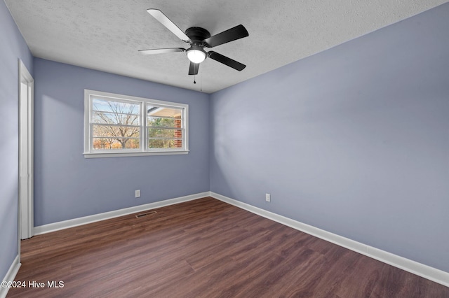 spare room with ceiling fan, dark hardwood / wood-style flooring, and a textured ceiling