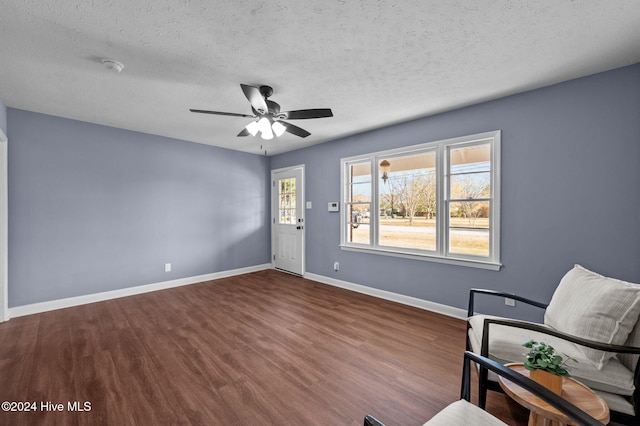 unfurnished room with wood-type flooring, a textured ceiling, and ceiling fan