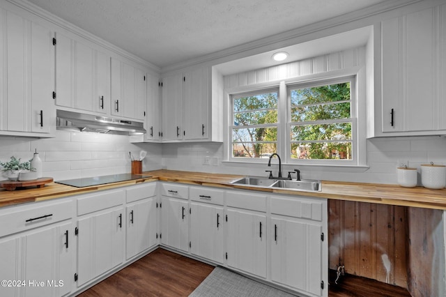 kitchen with white cabinets, dark hardwood / wood-style flooring, black electric cooktop, and sink