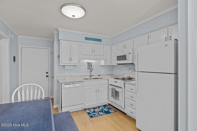 kitchen featuring sink, white cabinetry, light hardwood / wood-style flooring, ornamental molding, and white appliances