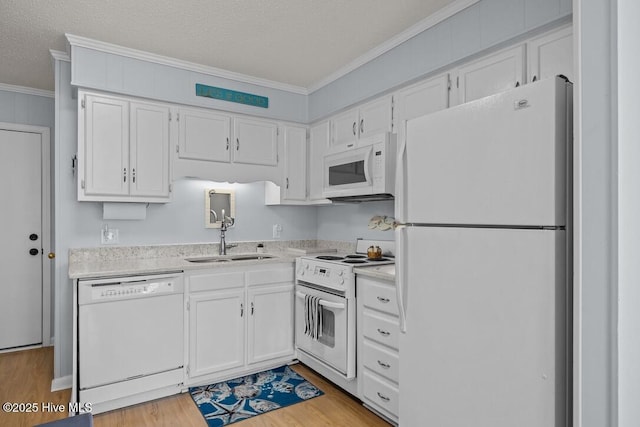 kitchen featuring white appliances, sink, and white cabinets