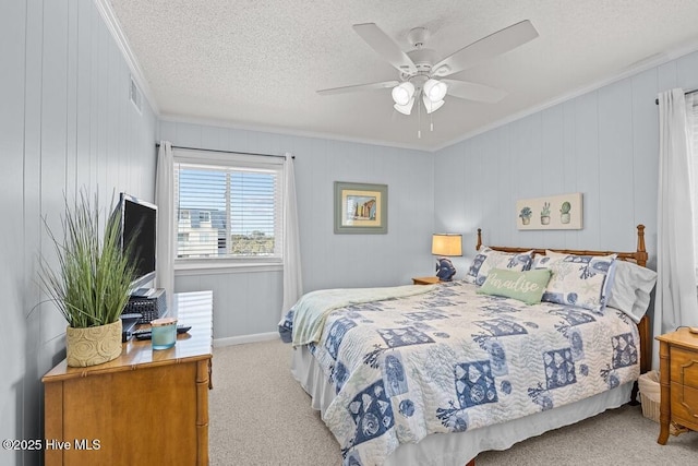 carpeted bedroom with crown molding, a textured ceiling, and ceiling fan