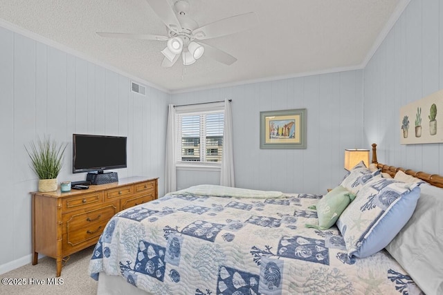 carpeted bedroom with crown molding, a textured ceiling, and ceiling fan