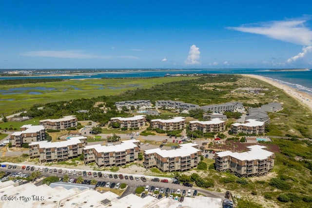 drone / aerial view featuring a water view and a view of the beach