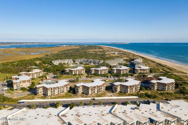 birds eye view of property featuring a beach view and a water view