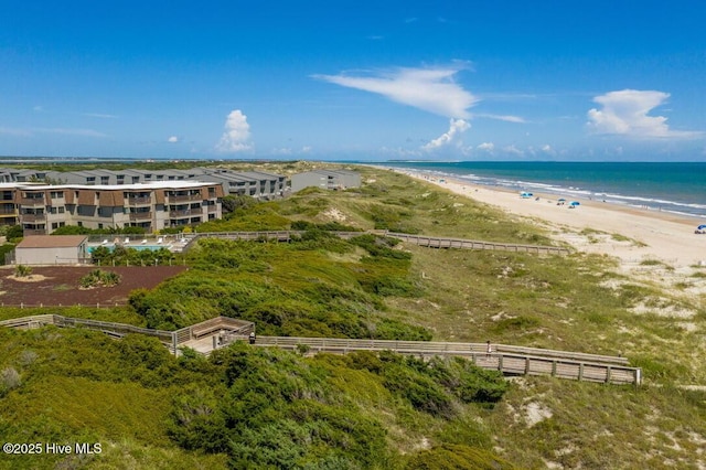 aerial view with a water view and a beach view