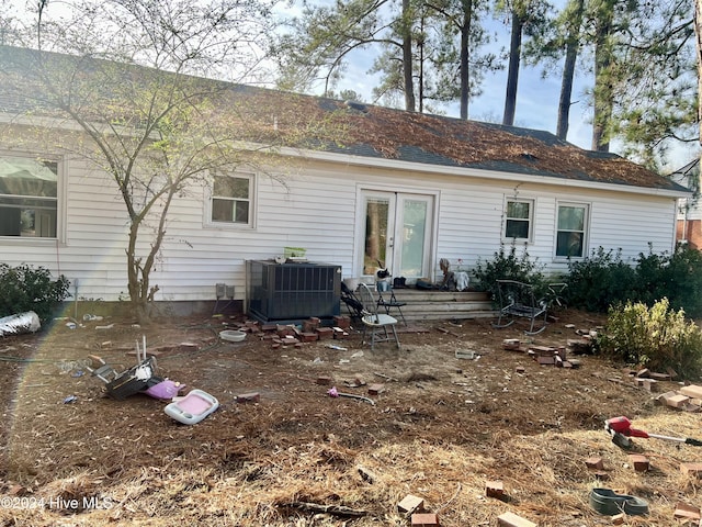 rear view of house featuring cooling unit