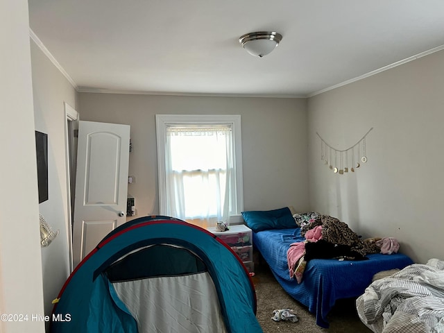 bedroom with crown molding and carpet