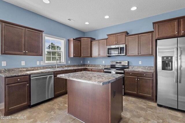 kitchen featuring dishwasher, a textured ceiling, and sink