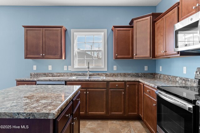 kitchen with light stone countertops, a textured ceiling, and stainless steel appliances