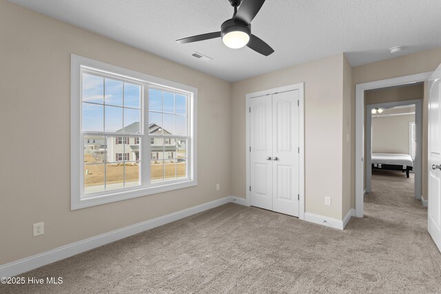 office space featuring carpet flooring, a wealth of natural light, and ceiling fan