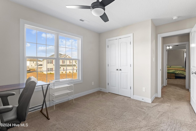 carpeted home office with ceiling fan