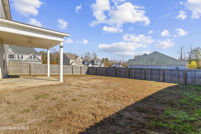 view of yard featuring ceiling fan and a patio area