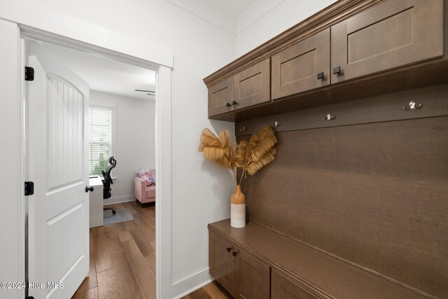 mudroom with hardwood / wood-style floors and ornamental molding