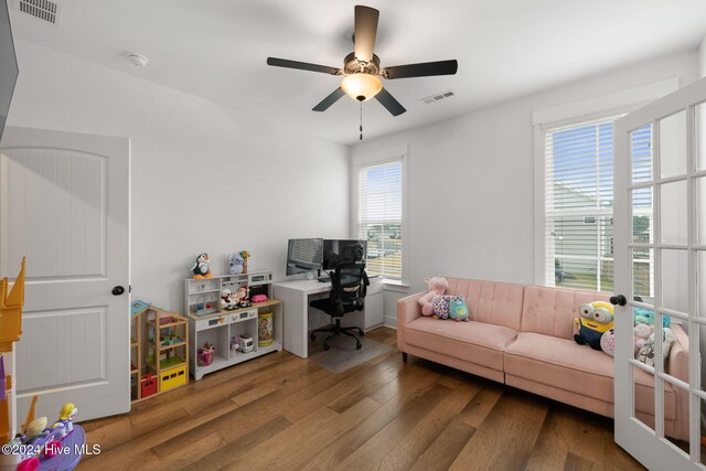 office space with wood-type flooring, ceiling fan, and french doors