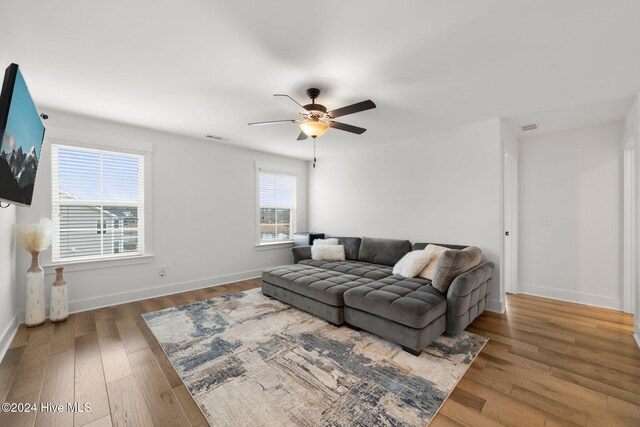 living room with hardwood / wood-style flooring and ceiling fan