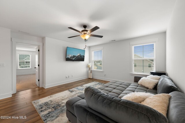 bedroom featuring wood-type flooring, multiple windows, and ceiling fan