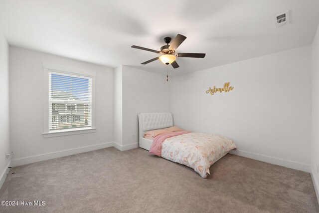 bedroom featuring ceiling fan and light carpet