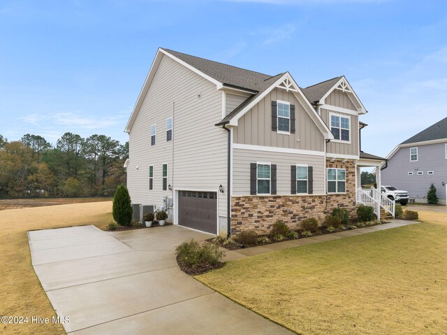 view of front of property with a garage and a front lawn