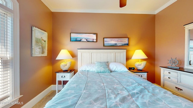 bedroom featuring ceiling fan, crown molding, and light carpet