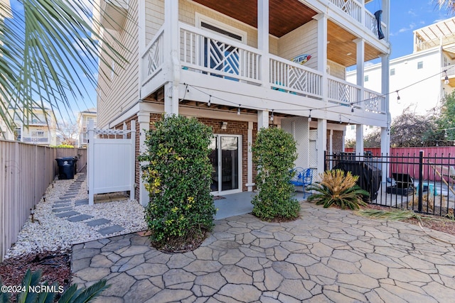 rear view of property featuring a balcony