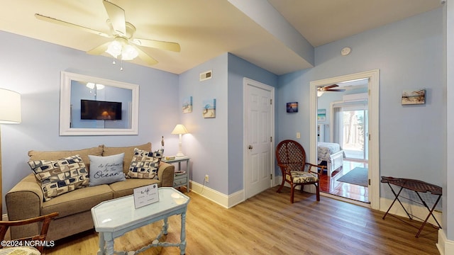 living room with ceiling fan and light hardwood / wood-style floors