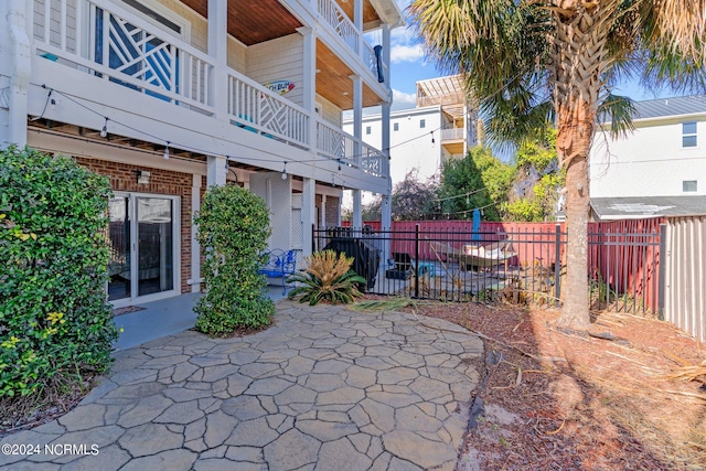 view of patio featuring a balcony