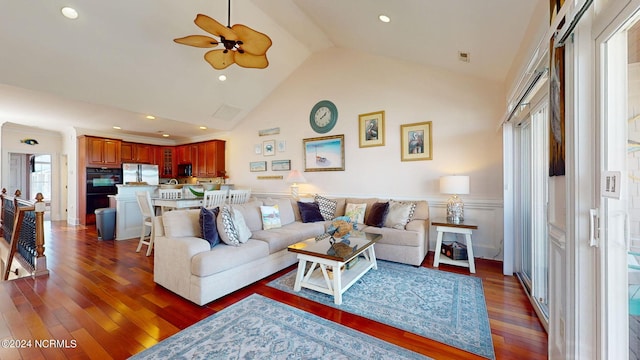 living room featuring dark hardwood / wood-style flooring, high vaulted ceiling, and ceiling fan