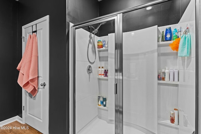 bathroom featuring a stall shower and wood finished floors