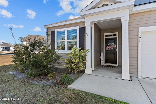 doorway to property featuring a garage and board and batten siding