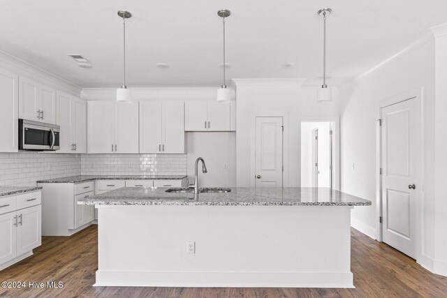 kitchen featuring dishwasher, dark hardwood / wood-style floors, light stone counters, and sink