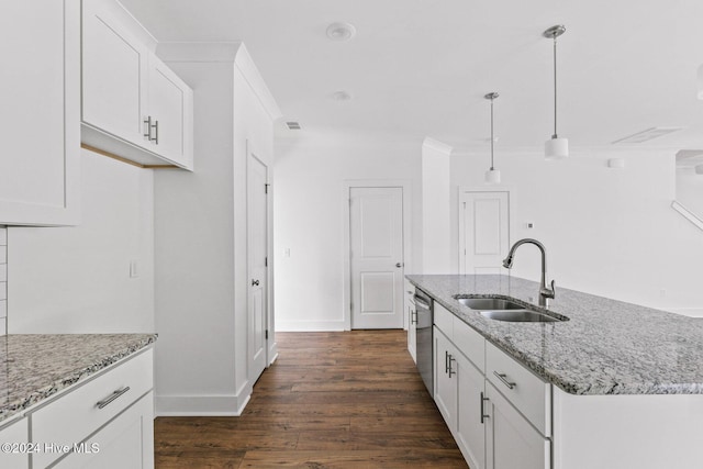 room details featuring backsplash, light stone counters, white cabinetry, and sink