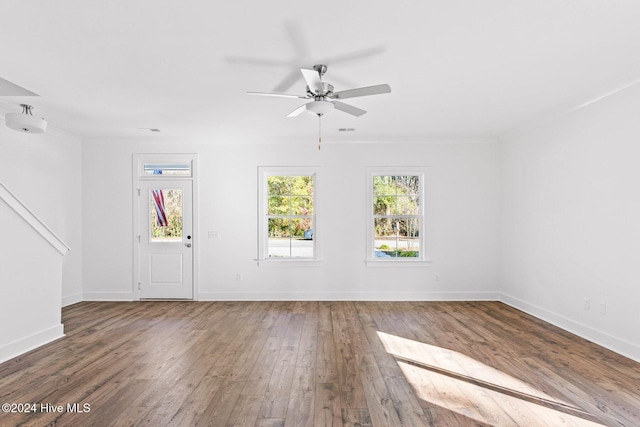 unfurnished living room featuring ceiling fan, dark hardwood / wood-style flooring, and sink