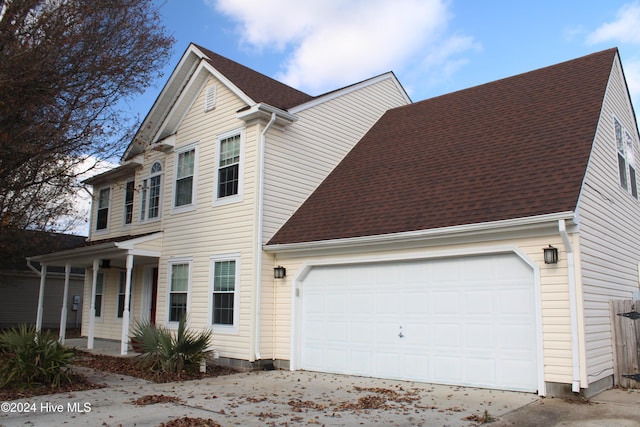 view of front facade featuring covered porch and a garage