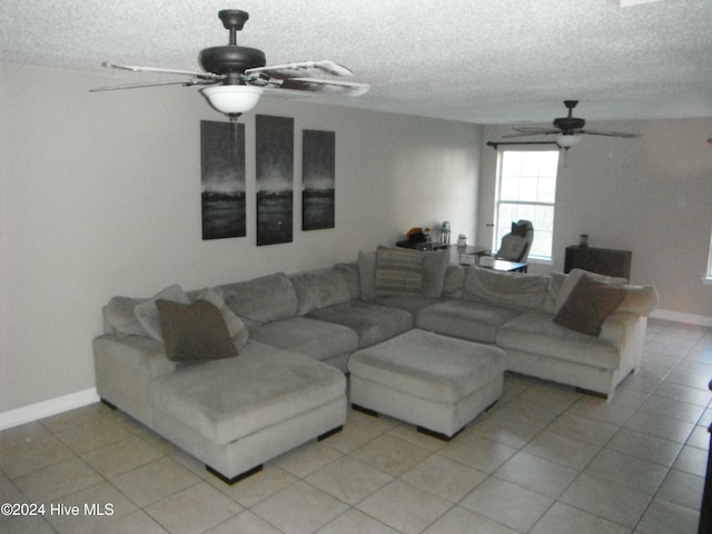 tiled living room featuring a textured ceiling